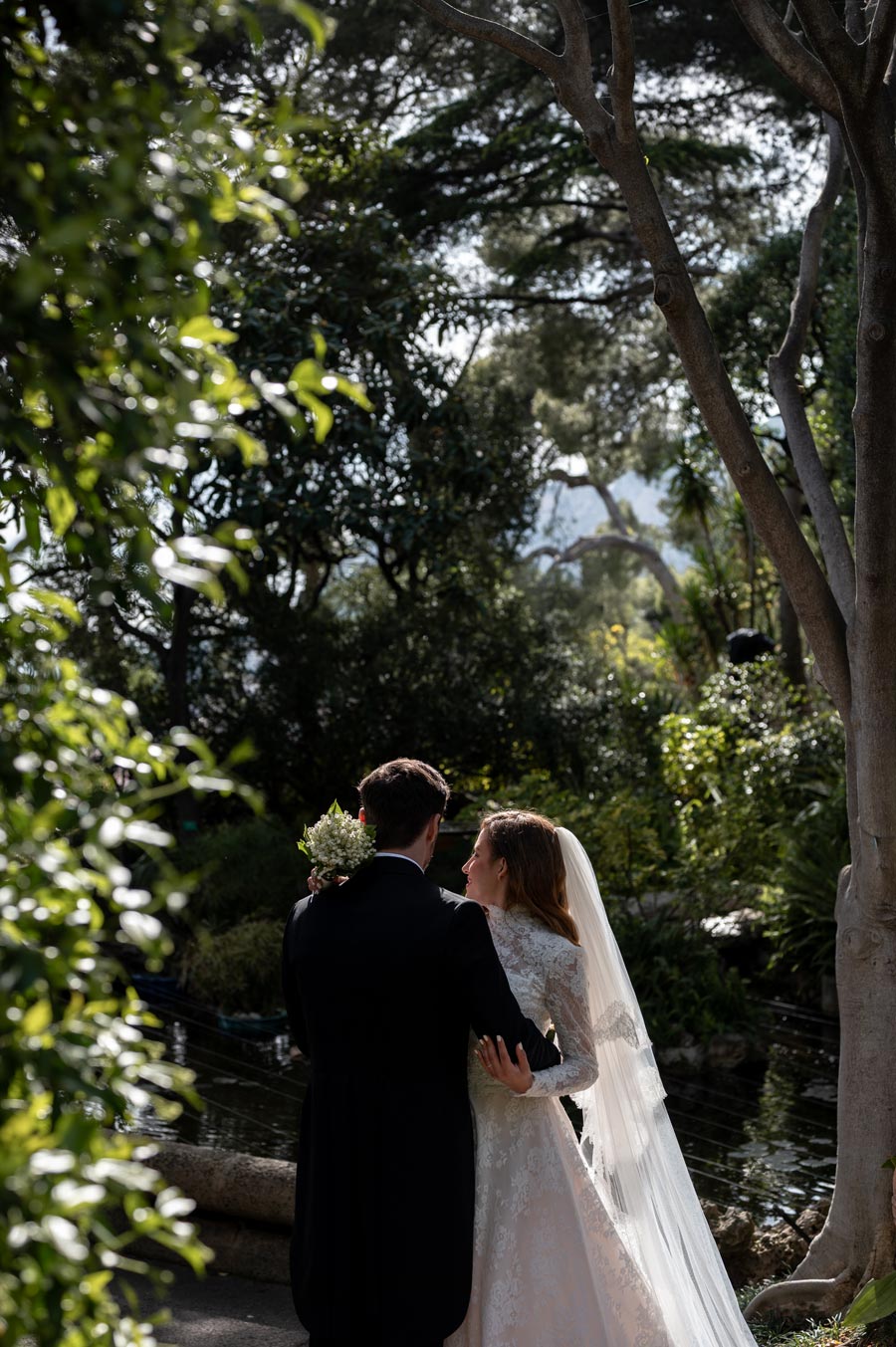 couple who are getting married in france under a tree hugging